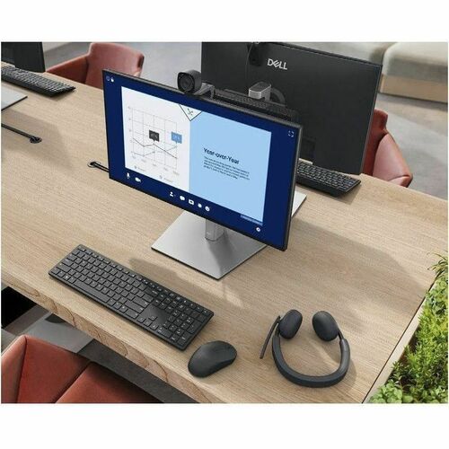 Computer setup on a desk with multiple monitors, keyboard, mouse, and headset.
