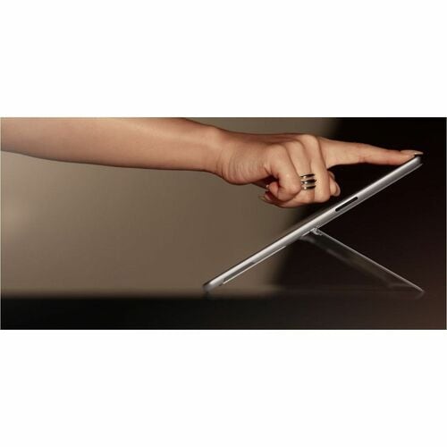 Hand holding a tablet device on a reflective surface