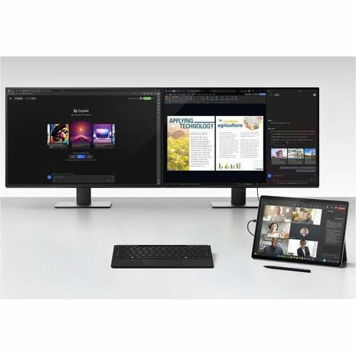 Multimonitor setup with a tablet and keyboard on a white surface