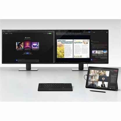 Multimonitor setup with a tablet and keyboard on a white surface