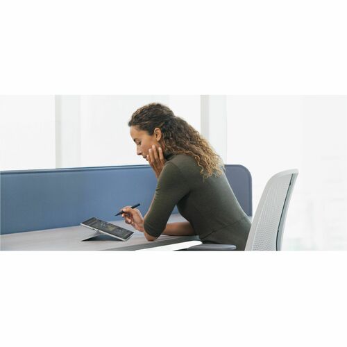 Person sitting at a desk using a tablet device with a white background