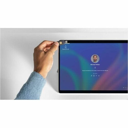 Hand holding a tablet with a colorful display on a white background