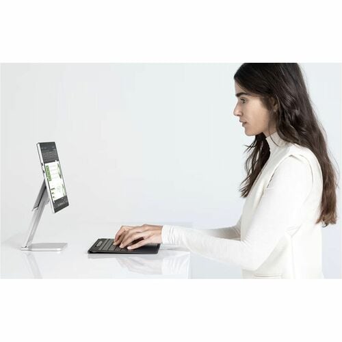 Woman using a computer with a white background