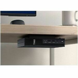 Toshiba computer tower under a desk with a neutral background