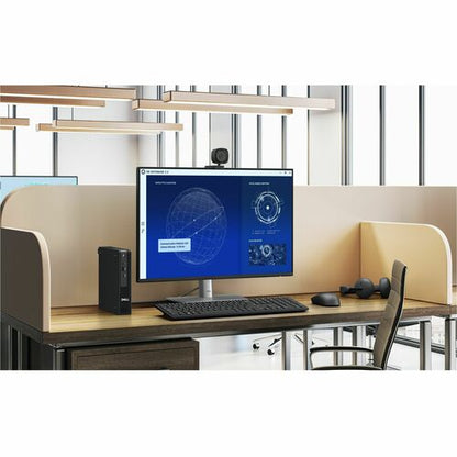 Computer setup on a desk with a monitor, keyboard, and mouse in an office environment.